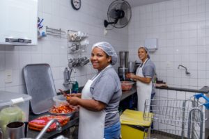 Equipe da cozinha sorridente em mais um dia de trabalho com muita responsabilidade na utilização dos recursos.